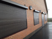 Black commercial shutters on front of buildings